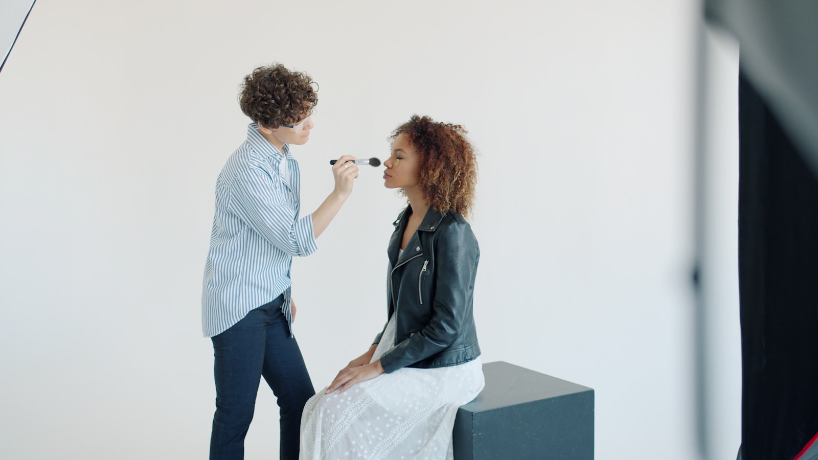 Makeup artist working with a performer in a production studio